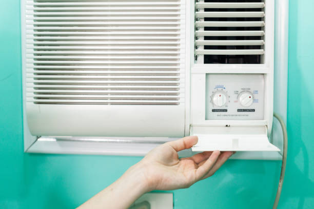istock Open panel adjustment of a small room air conditioner 993118458