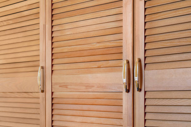 istock Modern wooden cabinet in classic rustic style. Details of wardrobe case with shutter plank doors. Country house interior 993123096