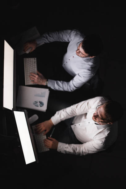 istock two businessmen making a financial report in the evening 993130904