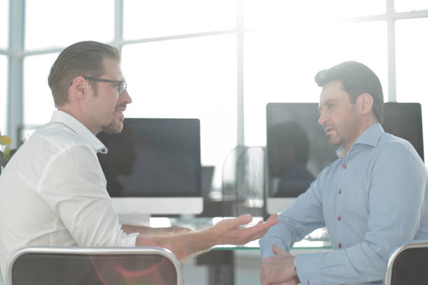istock rear view.two employees discussing new ideas 993139578