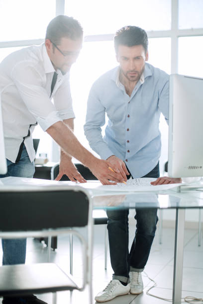 istock architect and the client discuss the sketches of the project 993139918