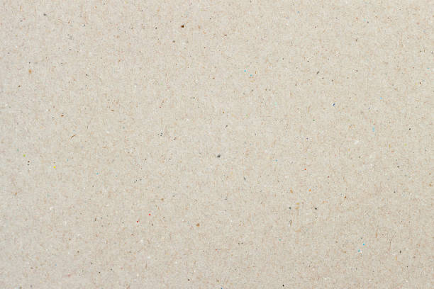 istock Texture of old ecological paper, background for design with copy space text or image. Recyclable material with small inclusions of cellulose 993156812