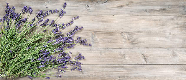 Lavender flowers on rustic wooden background. Vintage style still life