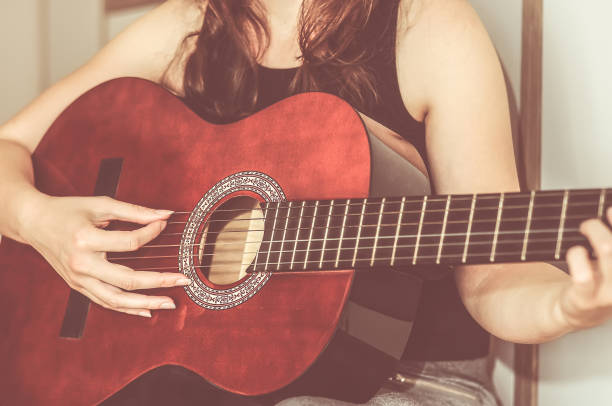 istock Young Girl Playing Guitar 993182008
