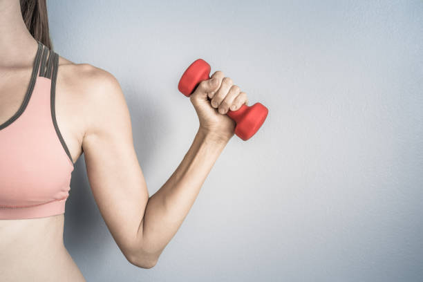 istock Young woman lifting weight. 993185800