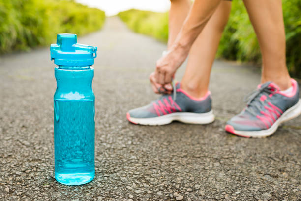 istock Female runner tying her shoes preparing for a jog 993185830