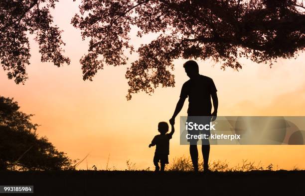 Padre Figlio Che Si Tiene Per Mano Camminando Insieme - Fotografie stock e altre immagini di Padre