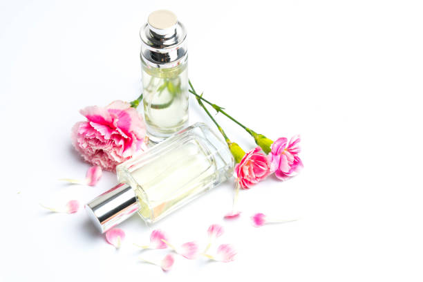istock Beautiful perfume bottles  and pink carnations on white background 993186720