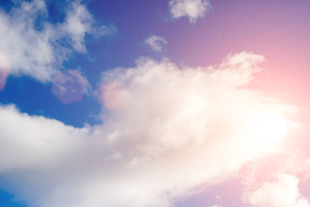 istock clouds against a blue sky with rays of the sun 993197224