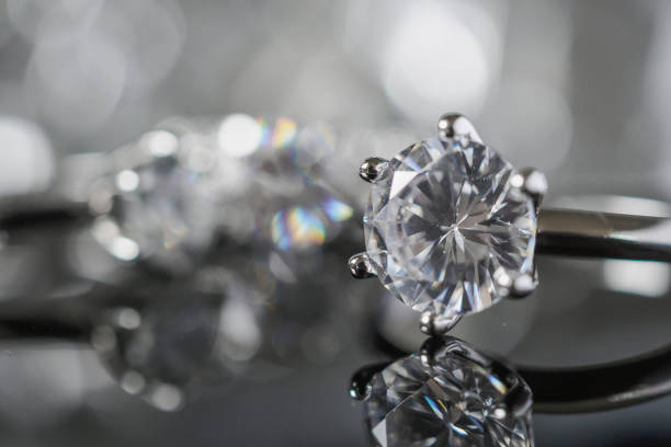 istock Luxury Jewelry diamond rings with reflection on black background 993197458