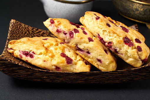 cranberry scone on black table