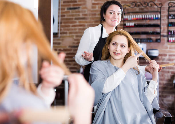 istock Glad woman points necessary length of hair 993223820