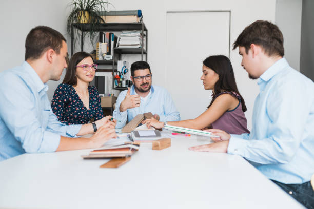 istock Young designers working and discussing plans in the office 993238056