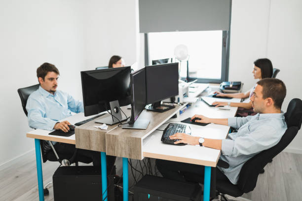 istock Team of young millennial people working in the office and using computers 993242396