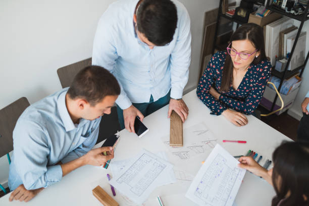 istock Architects making plans and drawings in the office 993243210