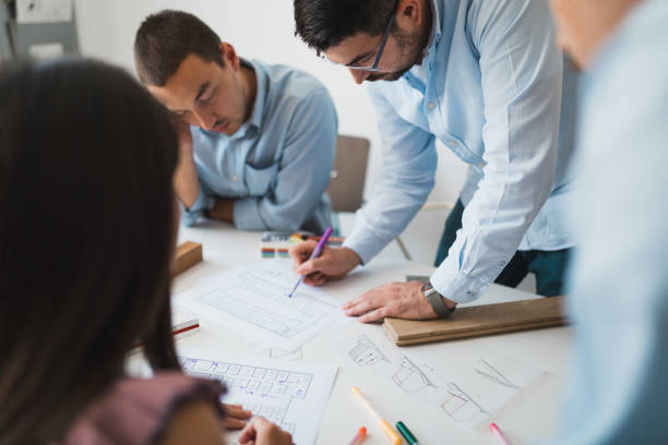 istock Architects making plans and drawings in the office 993243314