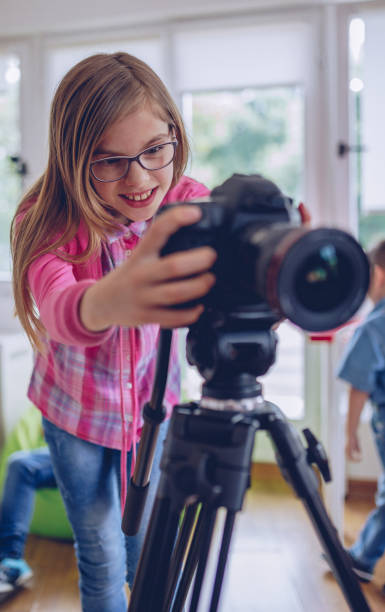 istock Cute girl photographer 993253752