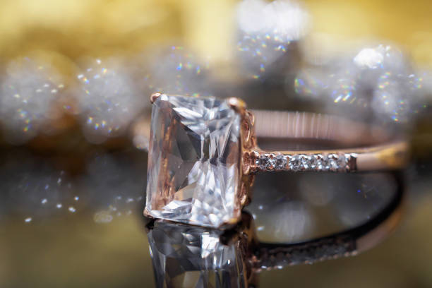 istock Luxury Jewelry diamond and pink topaz ring with reflection on black background 993254264