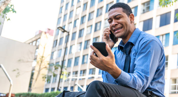 istock Man looks at cell phone and waits 993299464