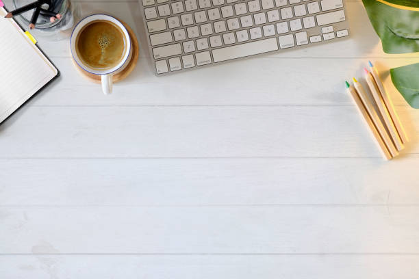 istock Office white wooden desk table with office supplies and copy space. 993308678
