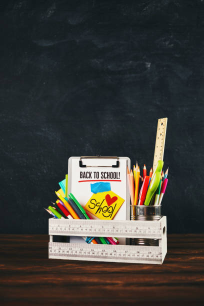 istock Back to school supplies in crate against weathered chalkboard 993329820