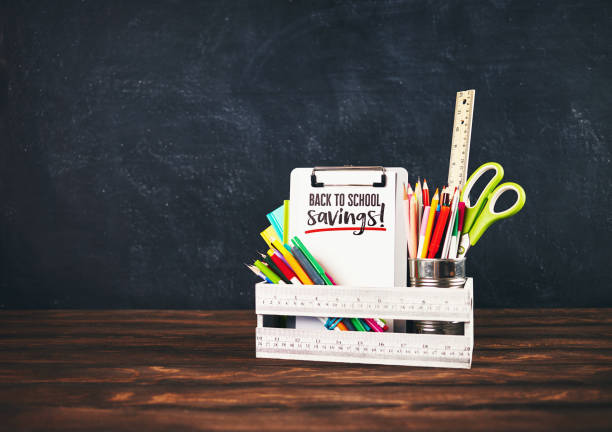istock Back to school supplies in crate against weathered chalkboard 993329842