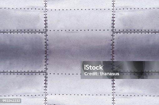 istock detail of old grunge piece of metal plate with bolts, aluminium surface background 993342232