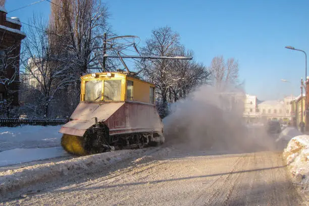 Old railroad snow cleaning tram in action, Liepaja, Latvia. Retro snow cleaning streetcar in action.