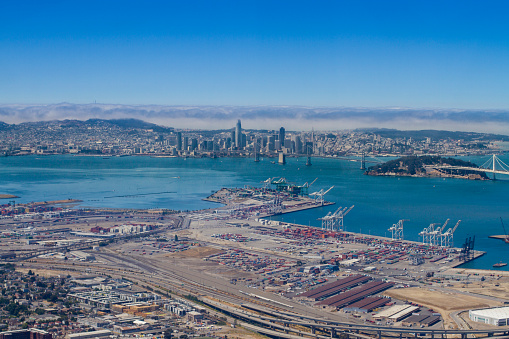 View of Fisherman's Wharf with old boats by the pier and background view of the hills in the city of San Francisco, the United States