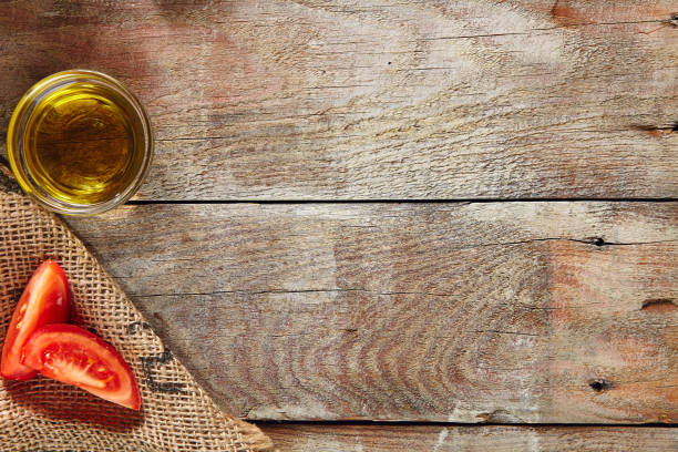 istock Sliced Tomatoes and Olive Oil on Wooden Rustic Background 993347474