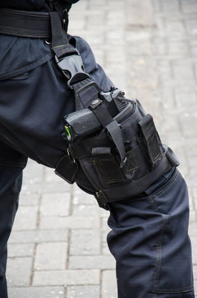 istock Leg of a policeman in which a firearm is found 993347918