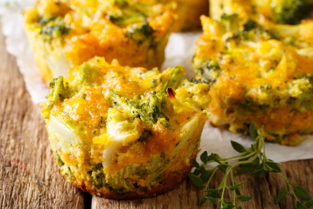 istock Freshly baked broccoli muffins with cheese and thyme close-up on parchment. horizontal 993355192