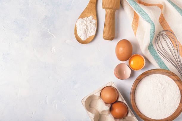 istock Ingredients for baking  - flour, wooden spoon, rolling pin, eggs. 993359590