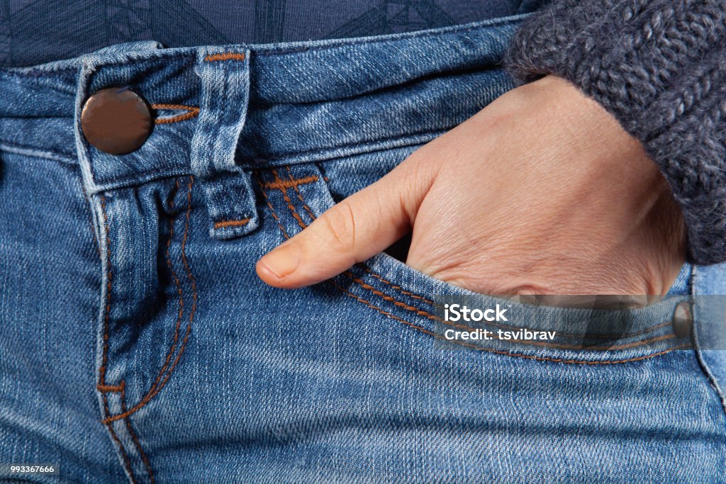 Female hand in blue jeans front pocket closeup Close-up Stock Photo