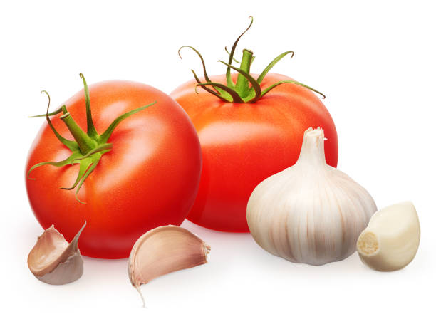 istock Red tomatoes with green leaves and garlic with cloves 993371230