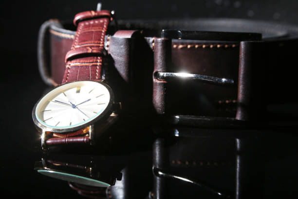 istock Men's accessories with brown leather wallet, belt and watch. 993380566