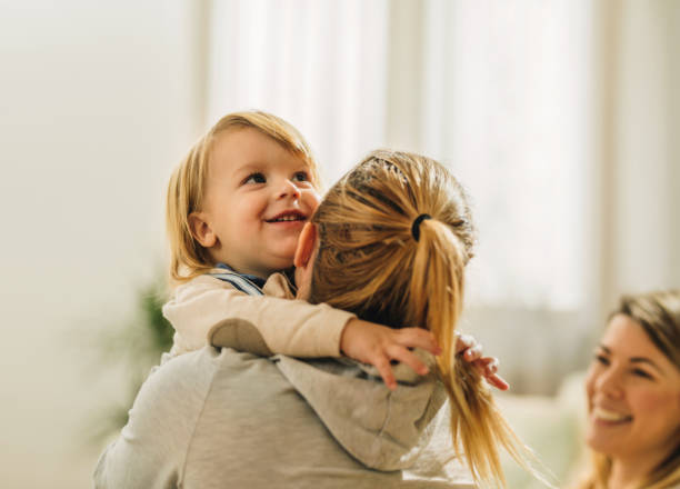 istock Cute happy boy embracing his mother at home. 993389442