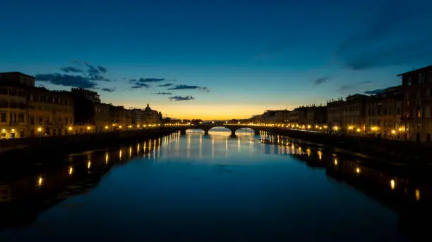 Sunset over the Arno river and Carraia bridge in Florence, Italy