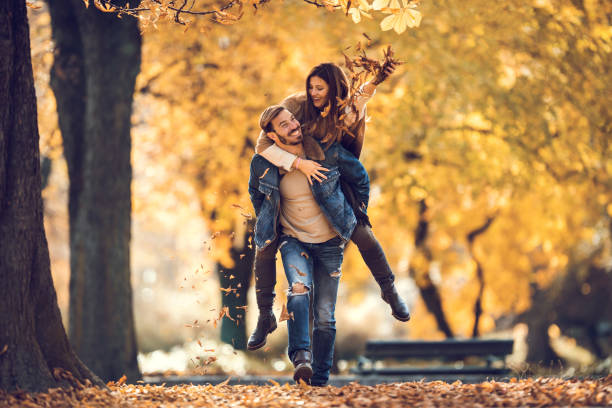 istock Young happy couple piggybacking and having fun in the forest. 993402084