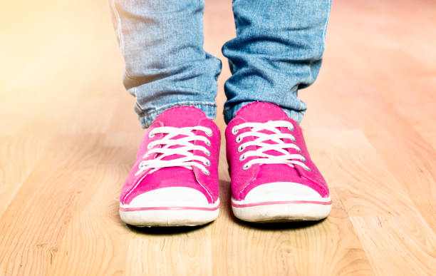 istock Shocking pink women's sneakers seen with jeans 993405030