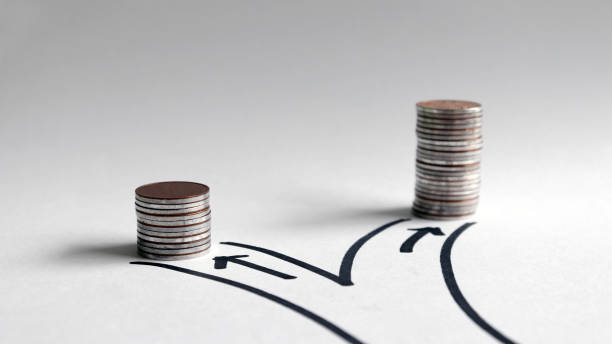 Two paths with different heights of coins. stock photo