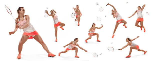 istock Young woman playing badminton over white background 993410314