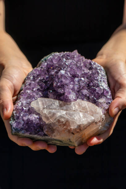 istock Hands holding a beautiful large piece of Amethyst 993423086
