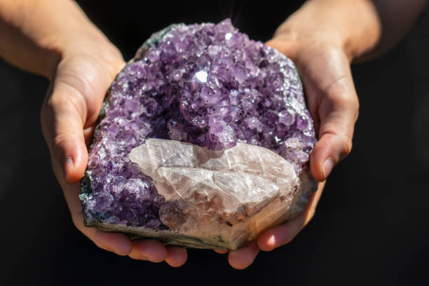istock Hands holding a beautiful large piece of Amethyst 993423124