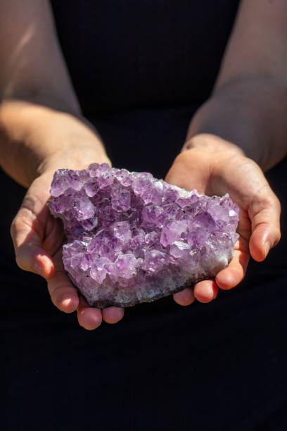 istock Hands holding a beautiful large piece of Amethyst 993424794