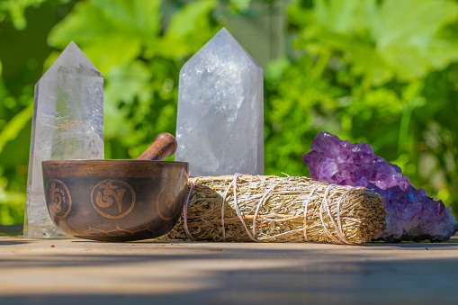 A Beautiful Tibetan Singing Bowl with Sage and several Crystals. Used for spiritual practice and healing.
