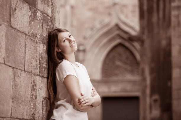 istock Young woman resting against old stone wall 993431522