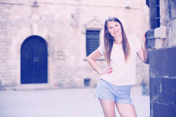 istock Young woman resting against old stone wall 993431574