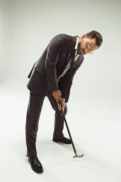 istock The barded man in a suit holding cane 993432388