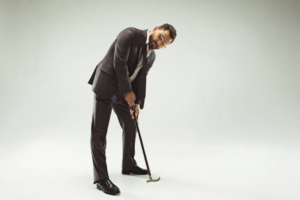 istock The barded man in a suit holding cane 993432510